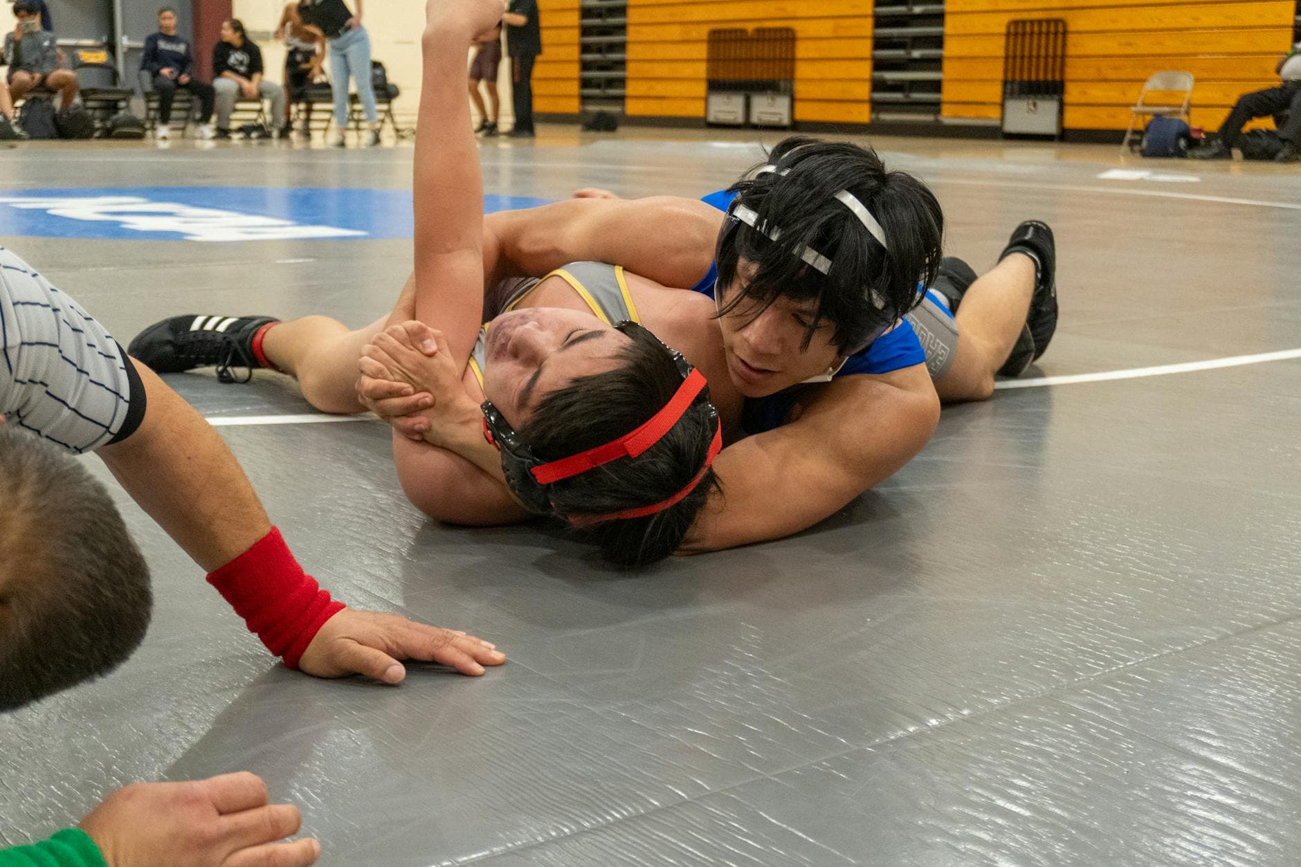 Teen wrestlers compete in an intense high school wrestling match in Cupertino, California.