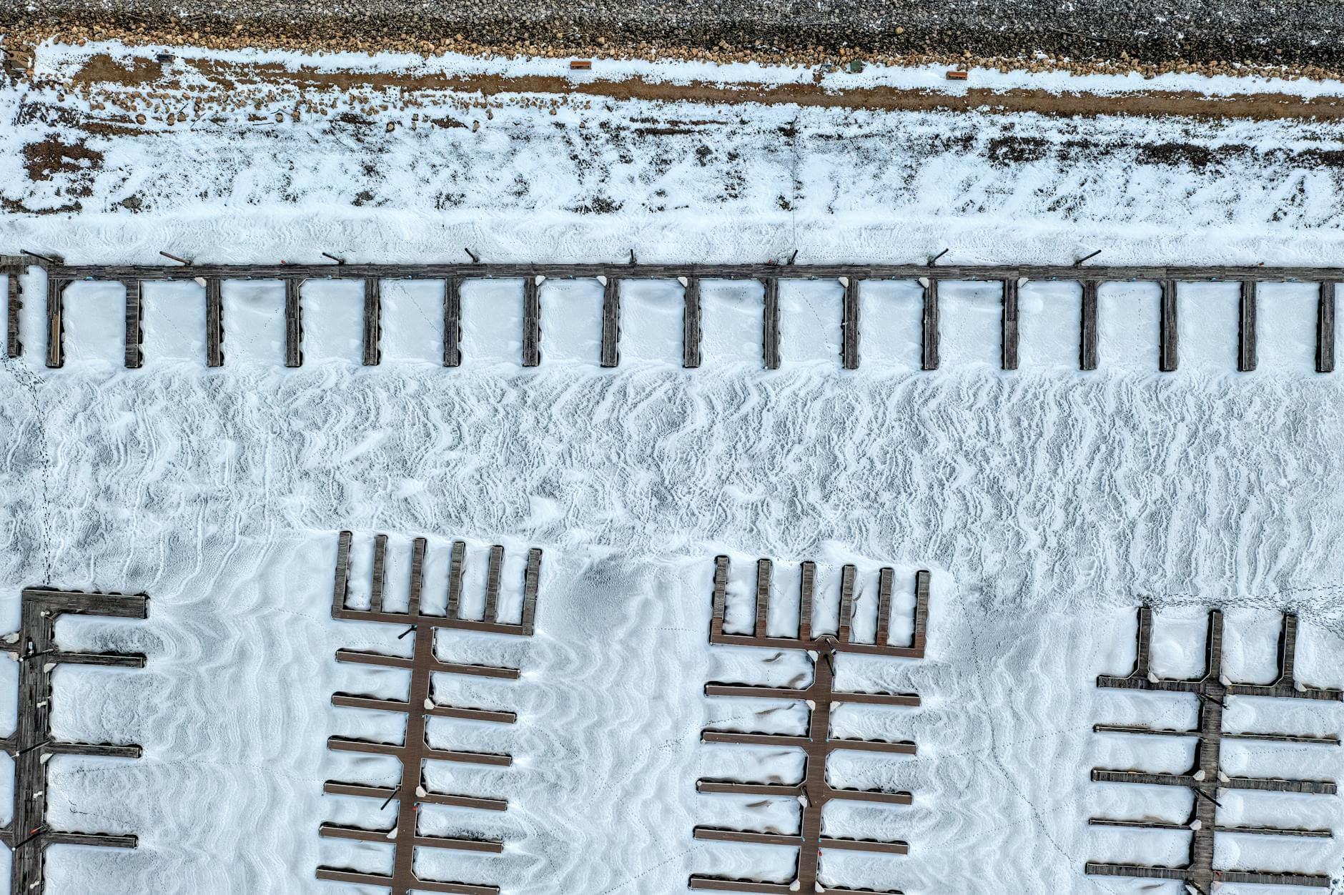 Aerial shot of an empty, snow-covered dock at Lake Pepin, Wisconsin.