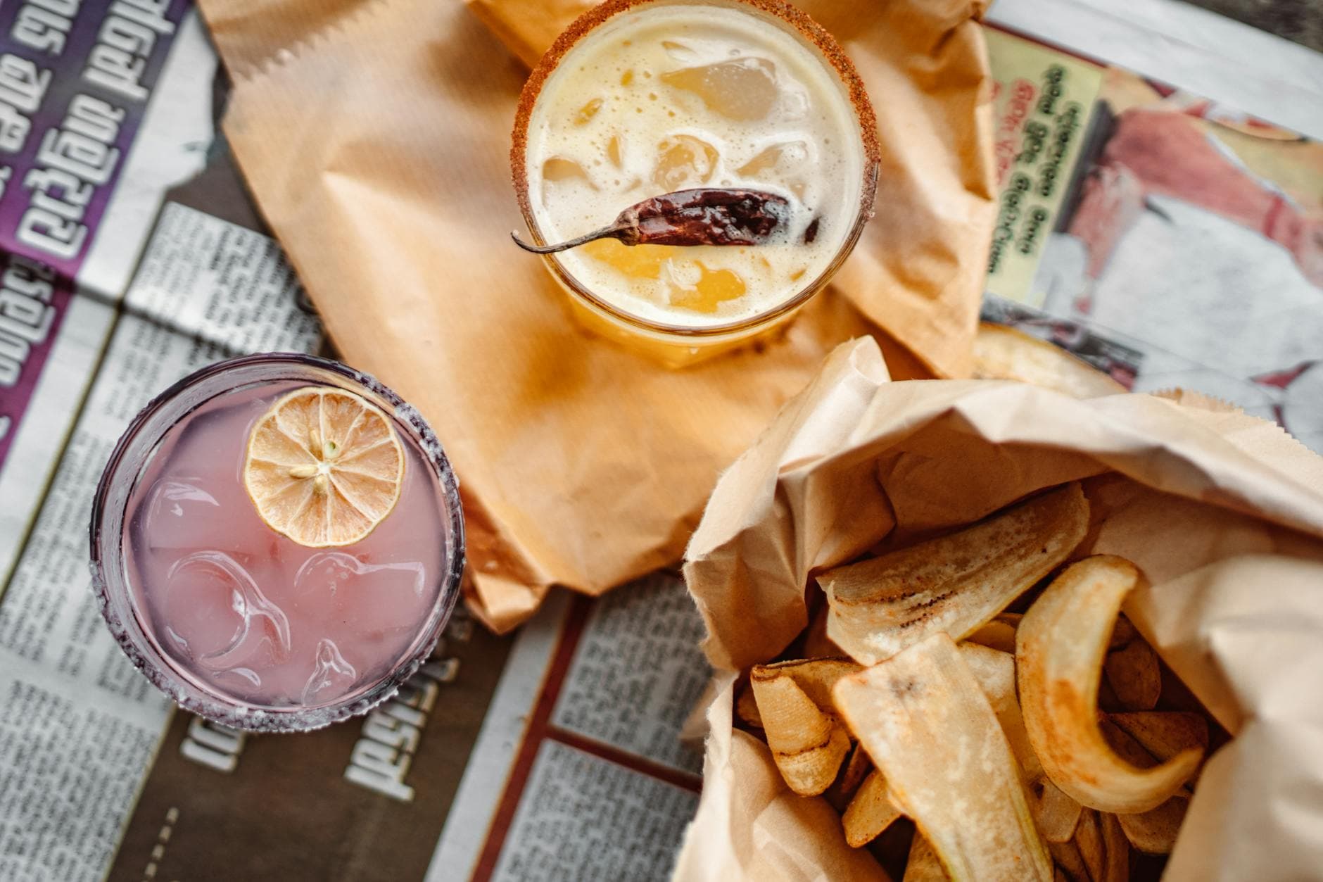 Delicious cocktails with fries on a newspaper background, perfect for a casual dining scene.