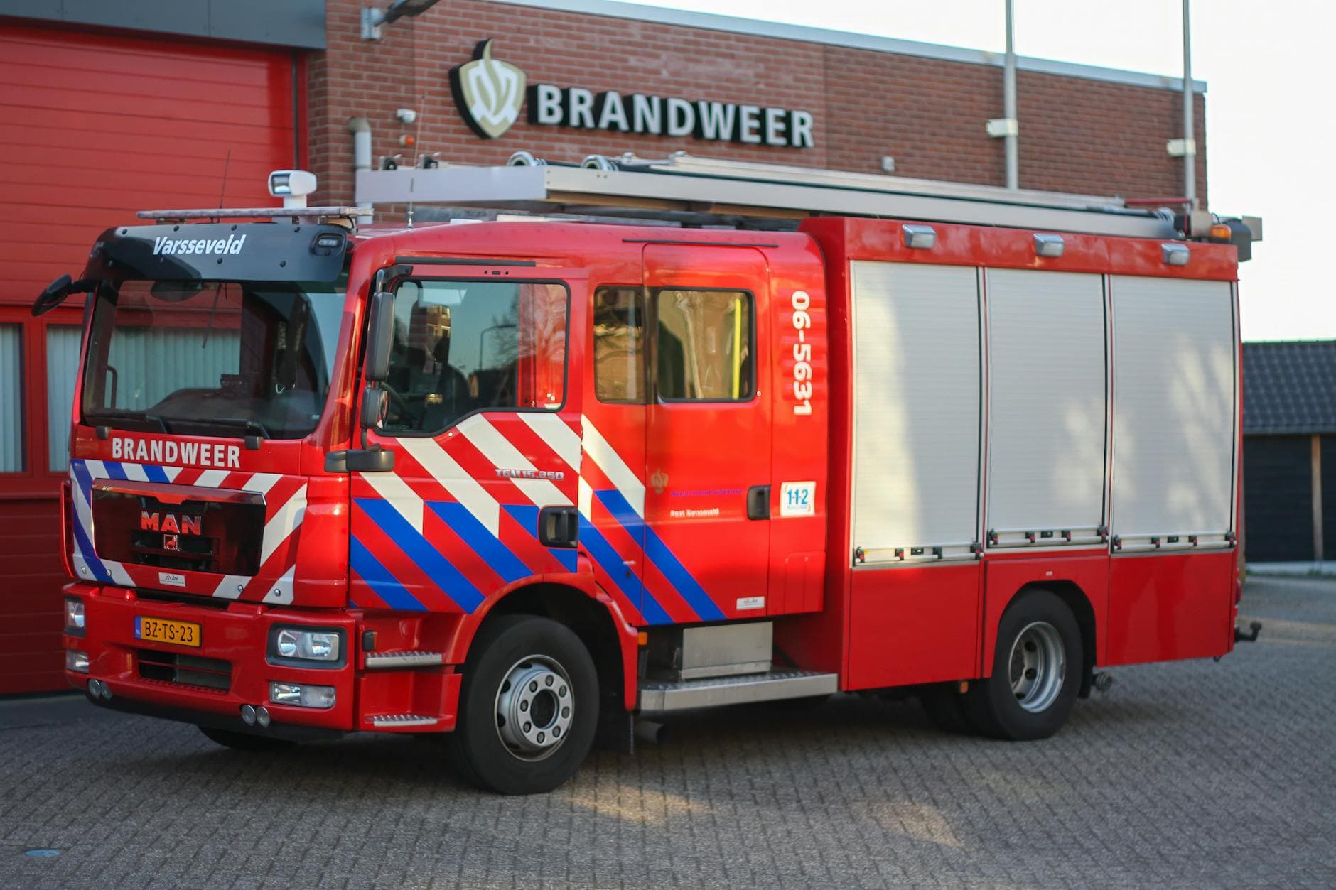 A vibrant red fire truck parked at a fire station in Varsseveld, Netherlands.