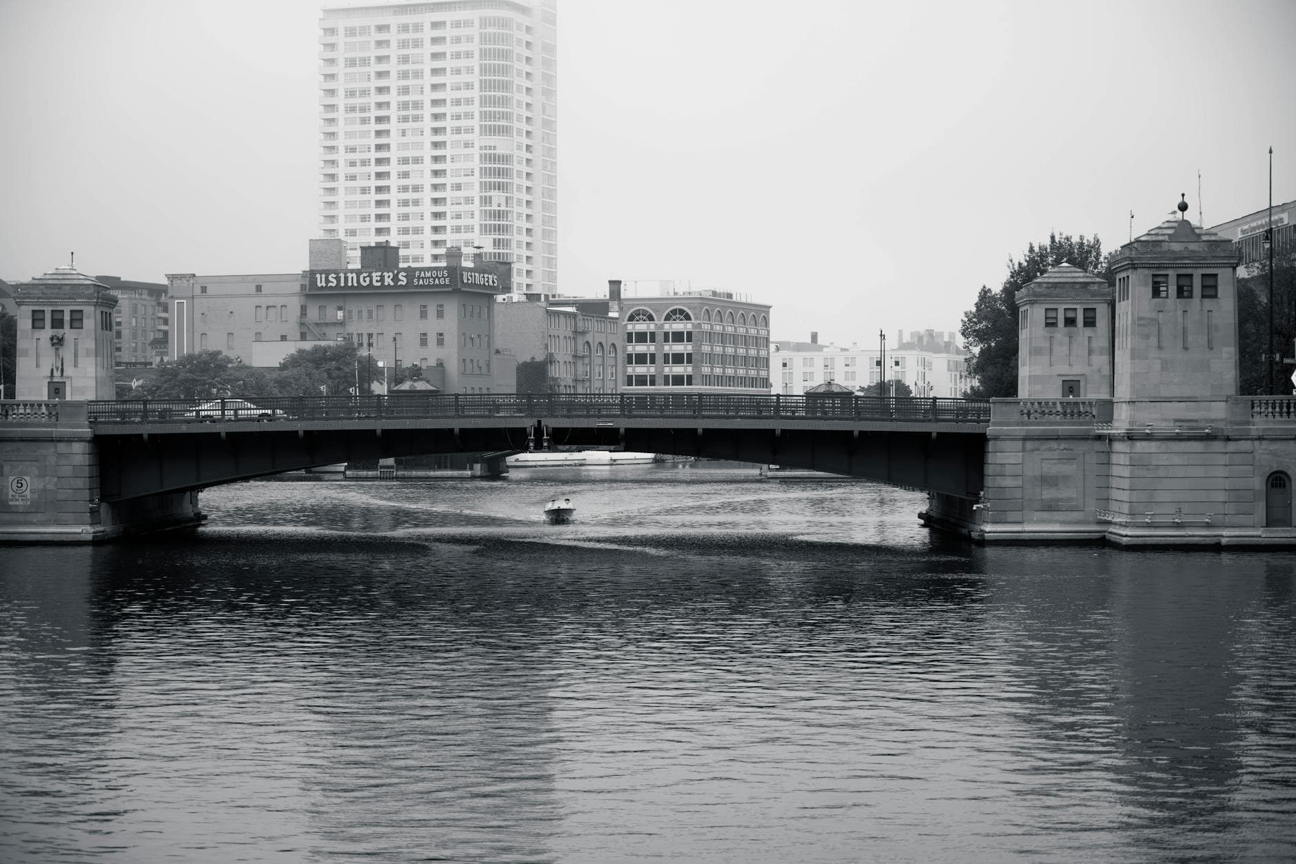 Scenic black and white view of Milwaukee's urban landscape featuring a prominent bridge and waterways.