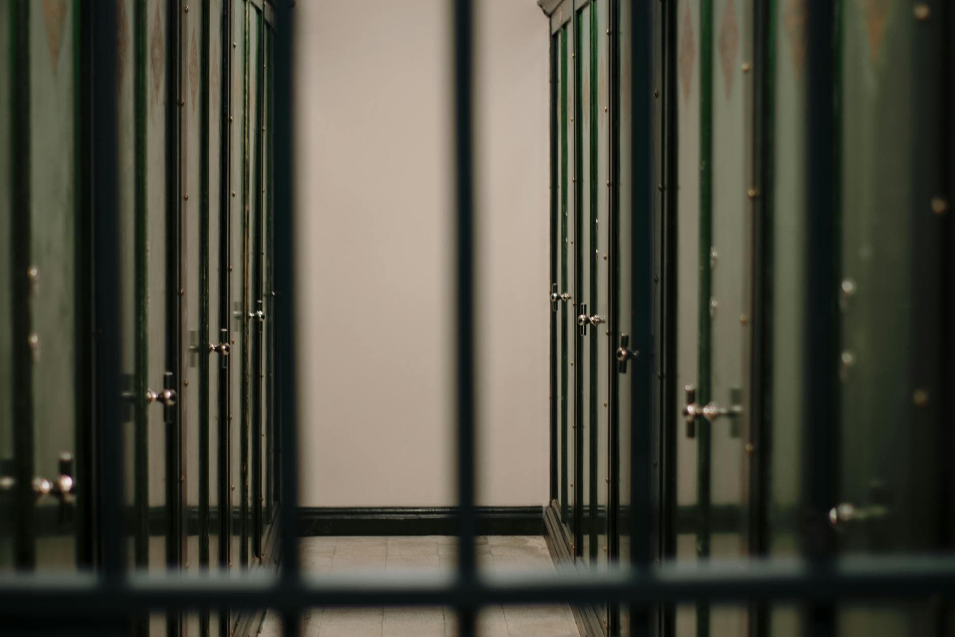 A serene interior view of a locker room featuring rows of green lockers and a calming atmosphere.