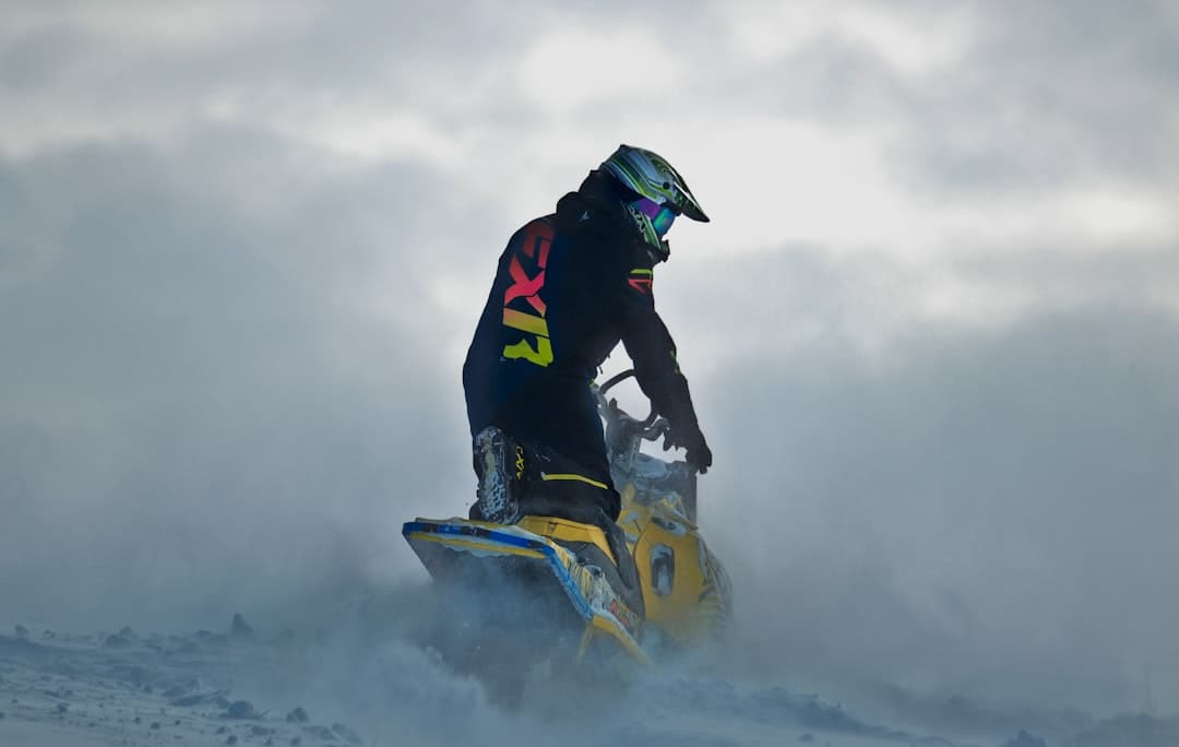 a man riding a snowmobile in the snow