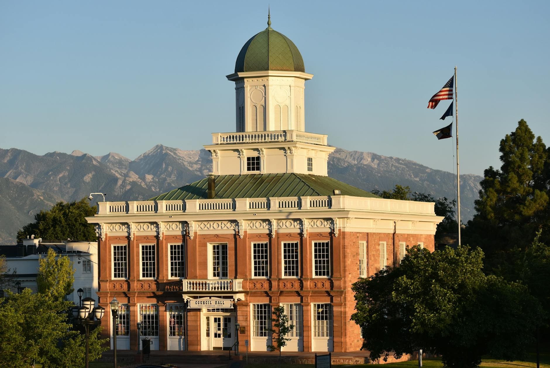 Stunning view of a historic church hall with mountains in the background.