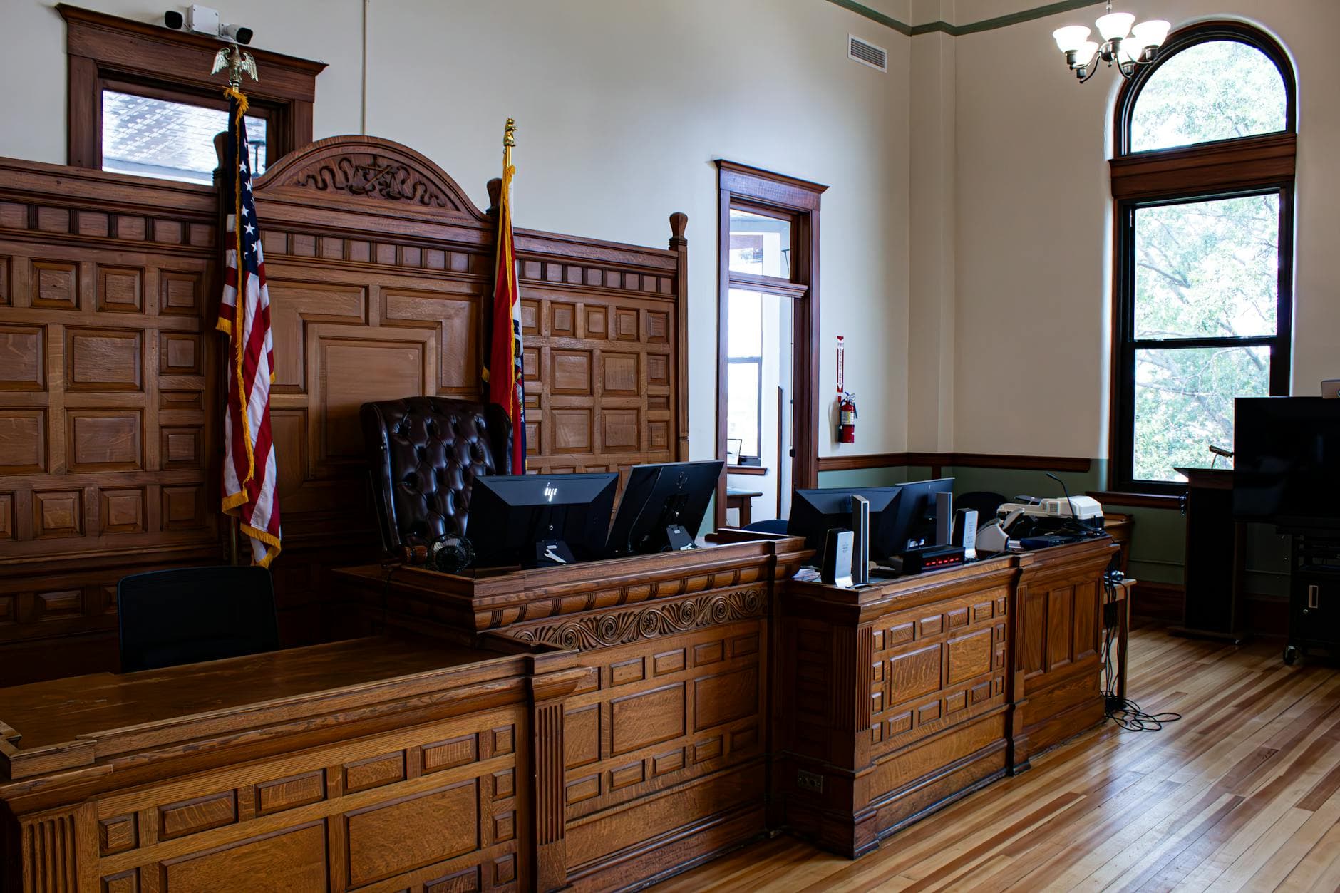 Interior view of an American courthouse in Kirksville, Missouri, featuring a judge's desk and flags.