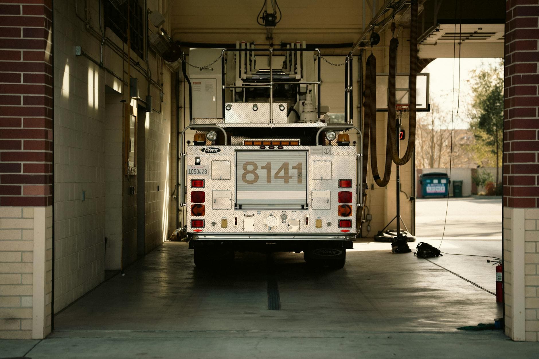 A fire truck parked inside a station's garage, showcasing emergency preparedness.