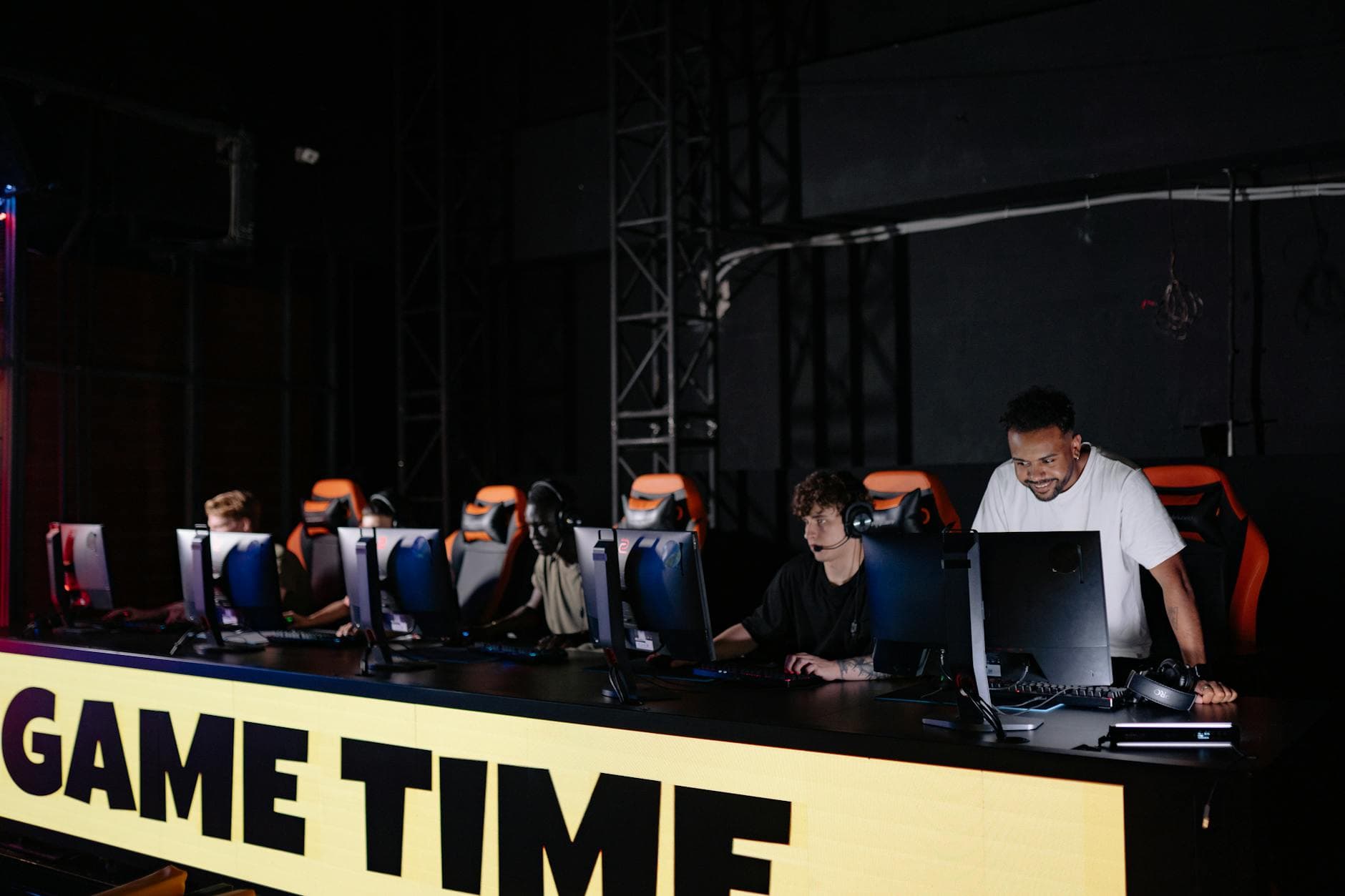 Esports team engaged in competitive gaming session indoors, showcasing teamwork and concentration.