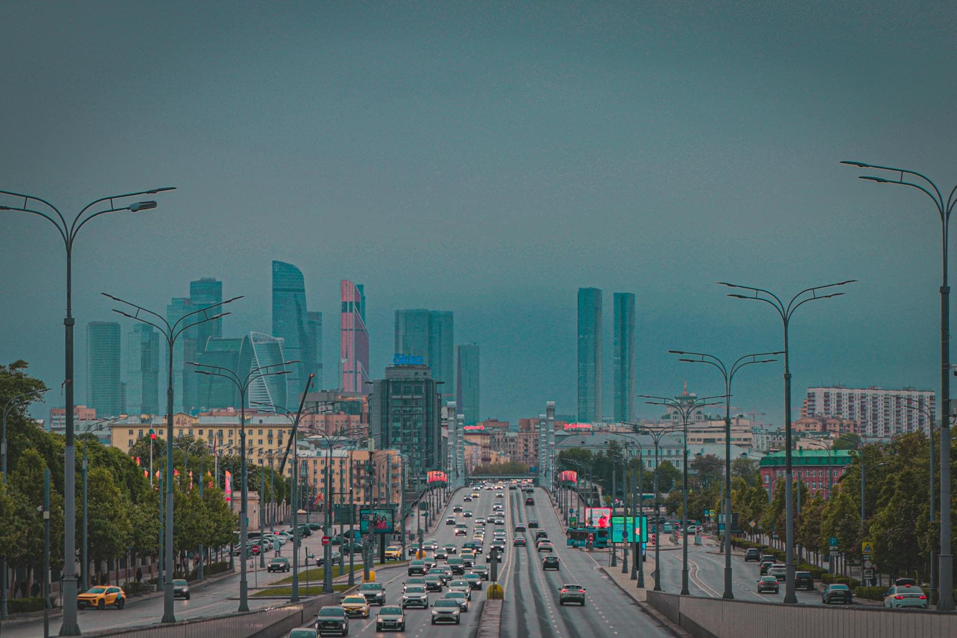 Dynamic view of Moscow City skyline with busy urban traffic and skyscrapers at dusk.