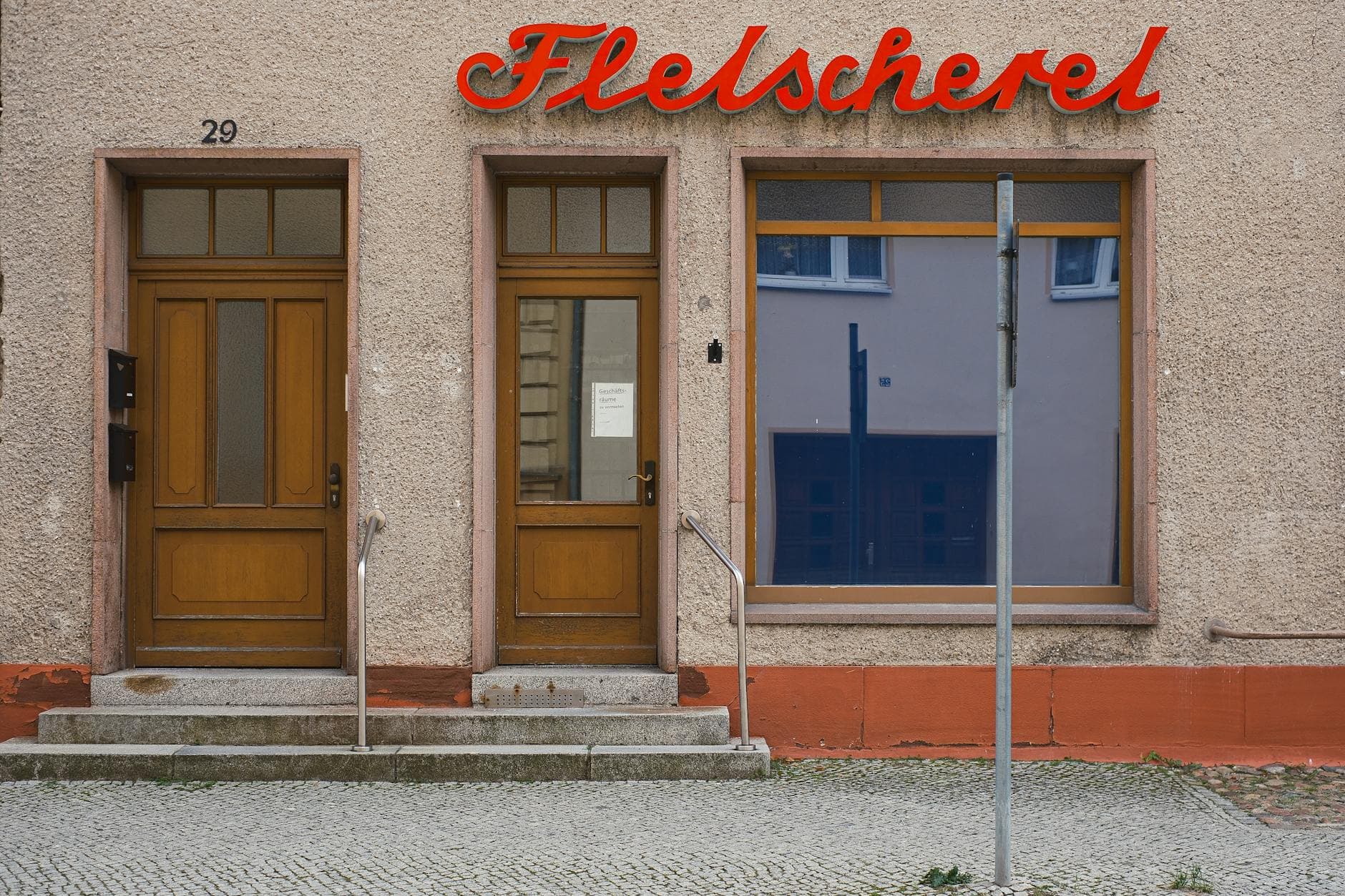 A quaint butcher shopfront with classic wooden doors in Luckau, Germany.