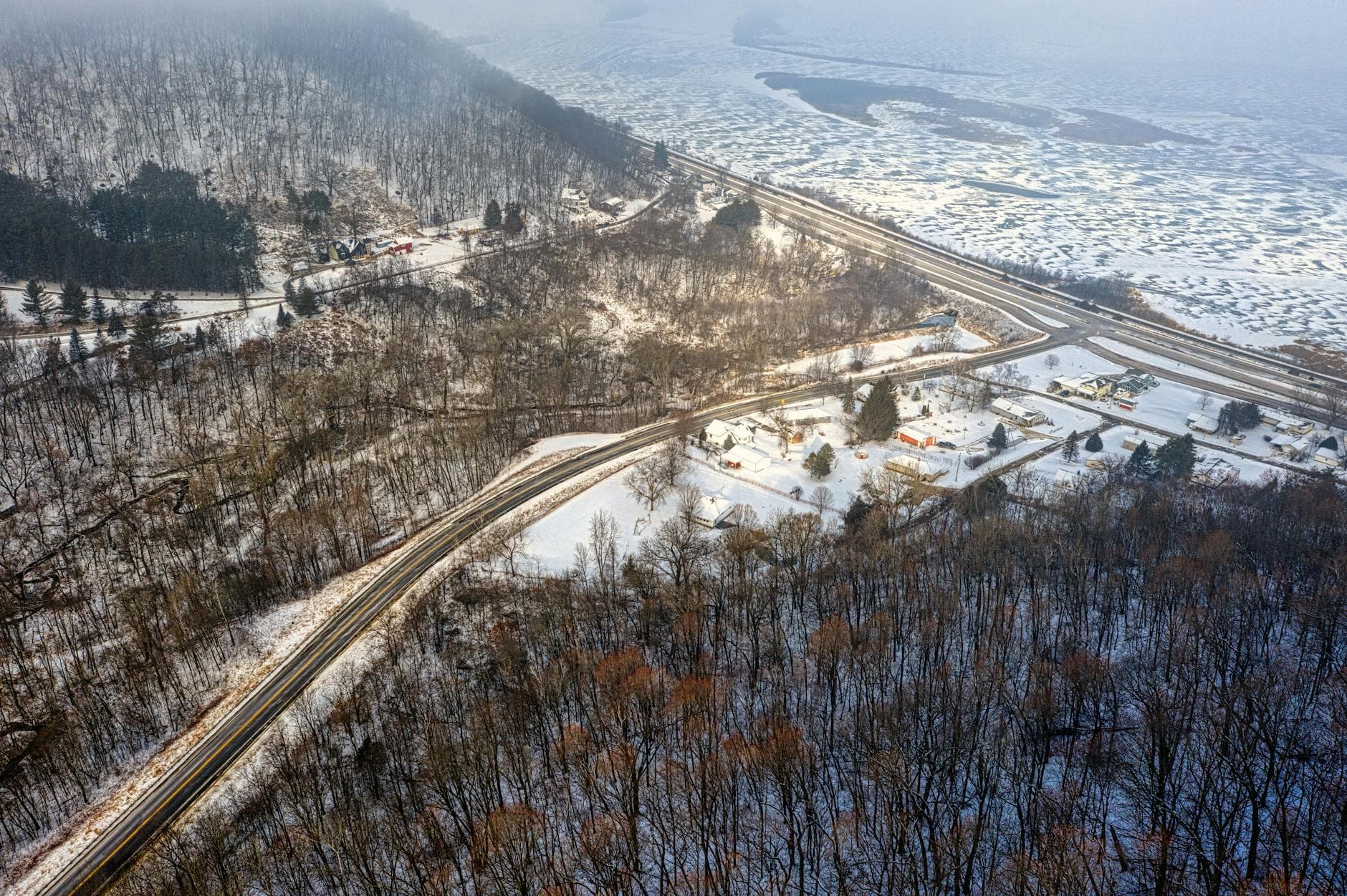 Aerial view capturing Lake City, MN's winter landscape with roads and snow-covered scenery.