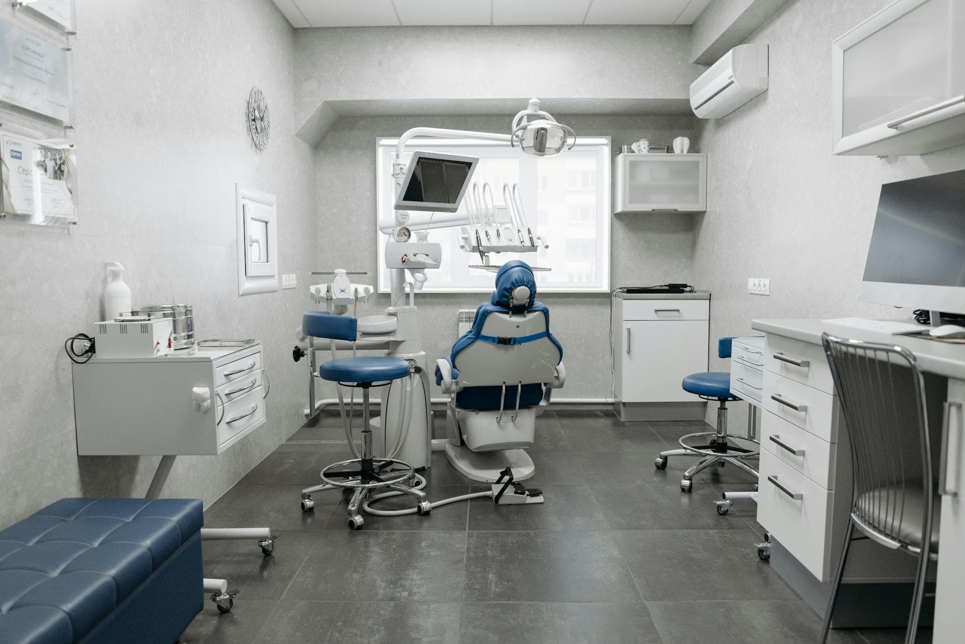 Spacious dental clinic with modern equipment and clean, white design.