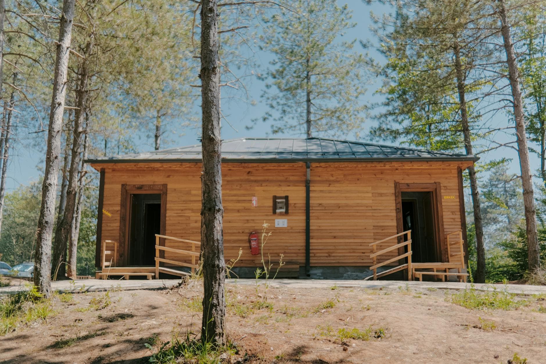 Charming wooden cabin nestled in a peaceful forest, ideal for a summer retreat.