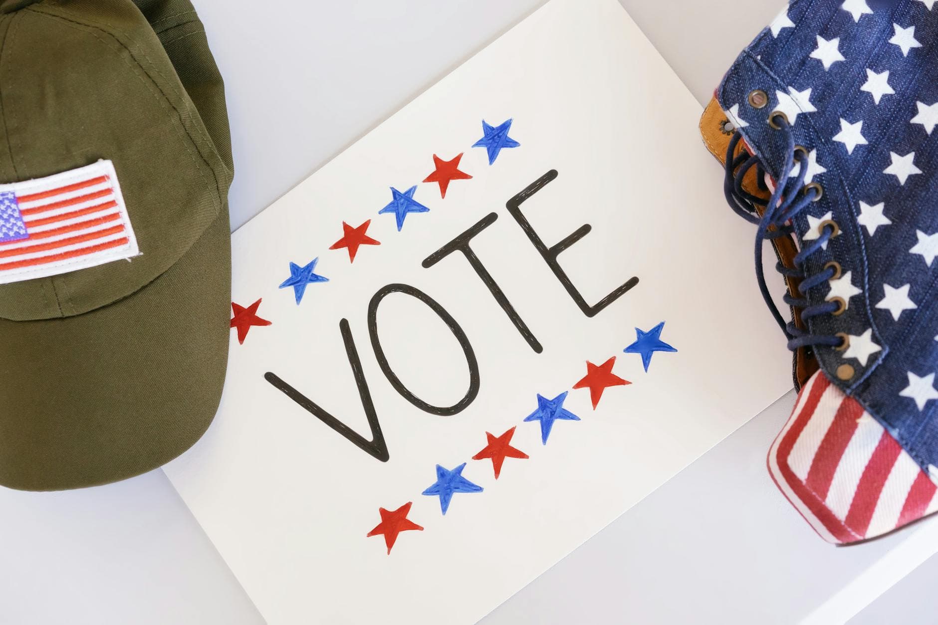 Flat lay of election-themed items promoting voting and democracy.
