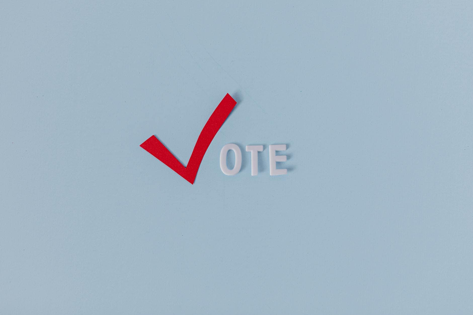 Red check mark with the word "VOTE" on a blue background, symbolizing election participation.