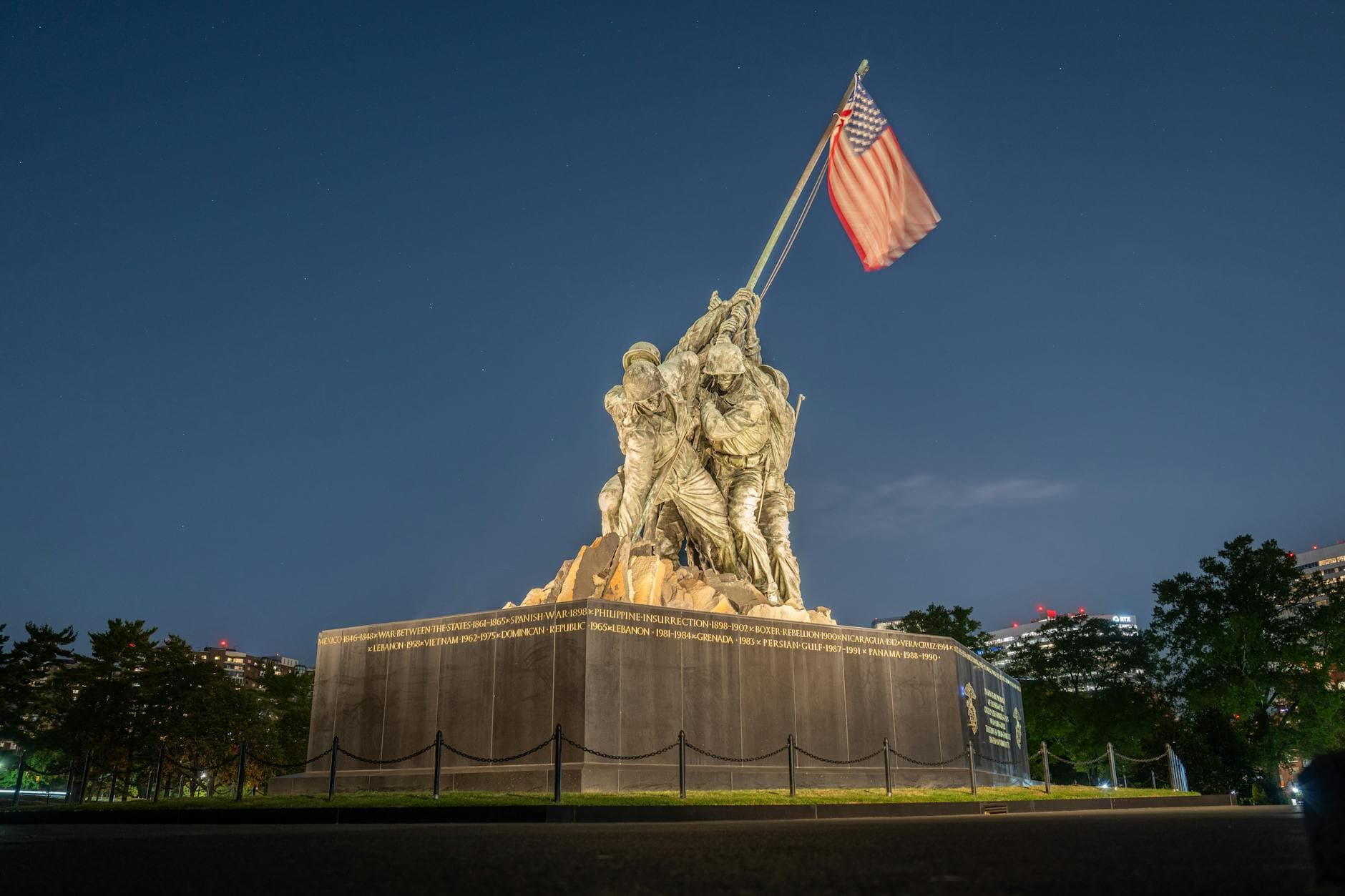 The iconic Iwo Jima Memorial illuminated under a clear night sky, showcasing its historical significance.