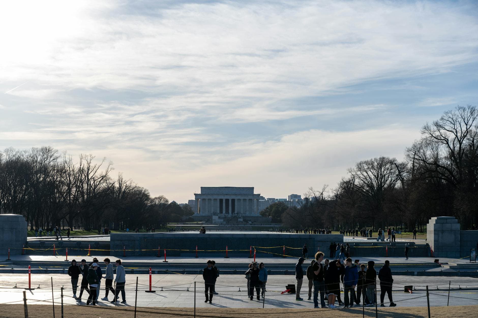 Tourists gather near the Lincoln Memorial in Washington DC on a clear day.