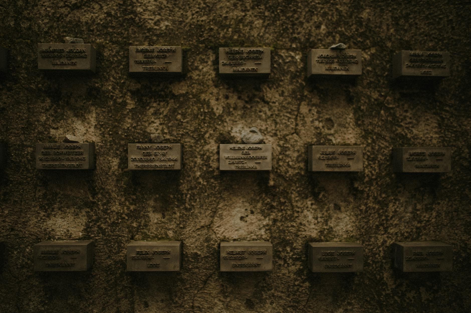 Wall of memorial plaques symbolizing remembrance of historical events.