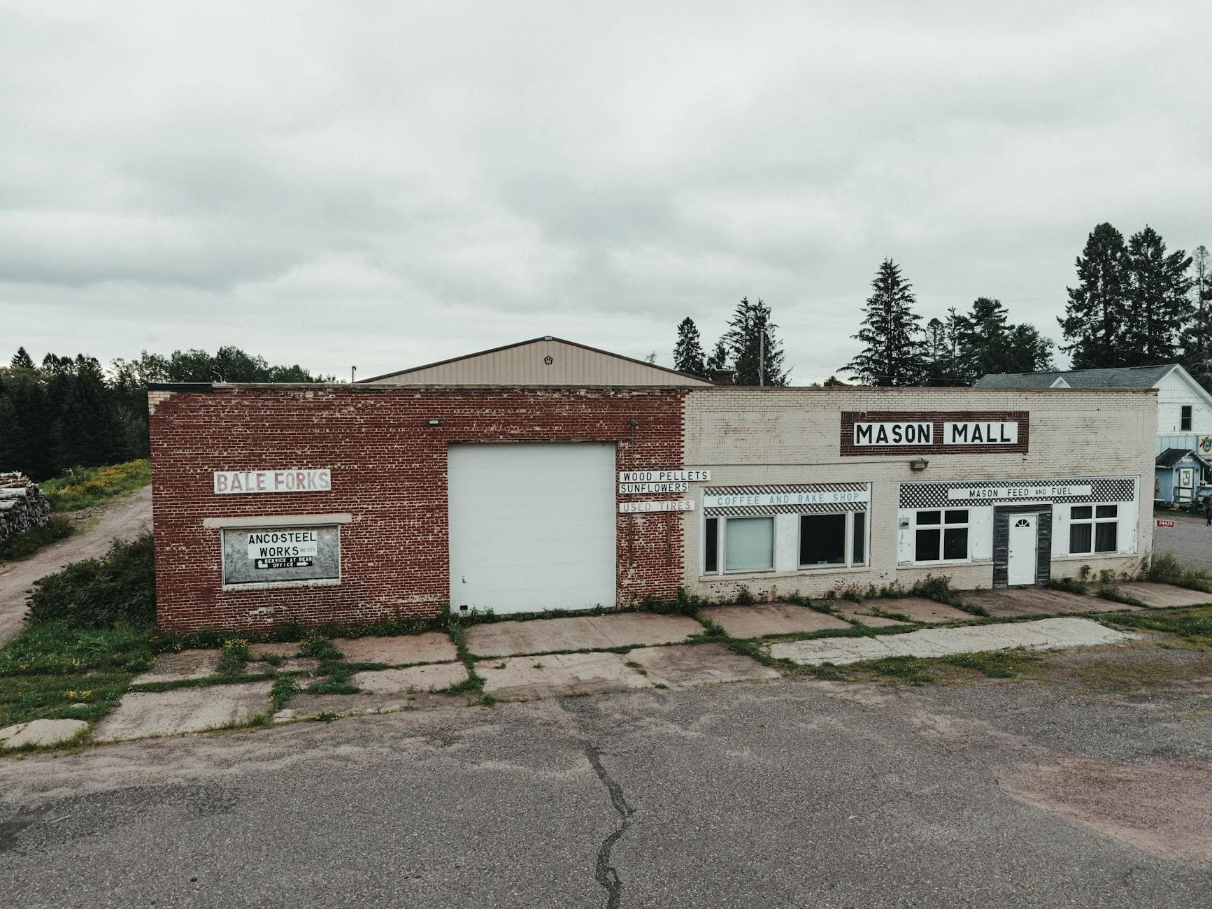 Aerial view of Mason Mall in Mason, WI showing rustic architecture and cloudy skies.