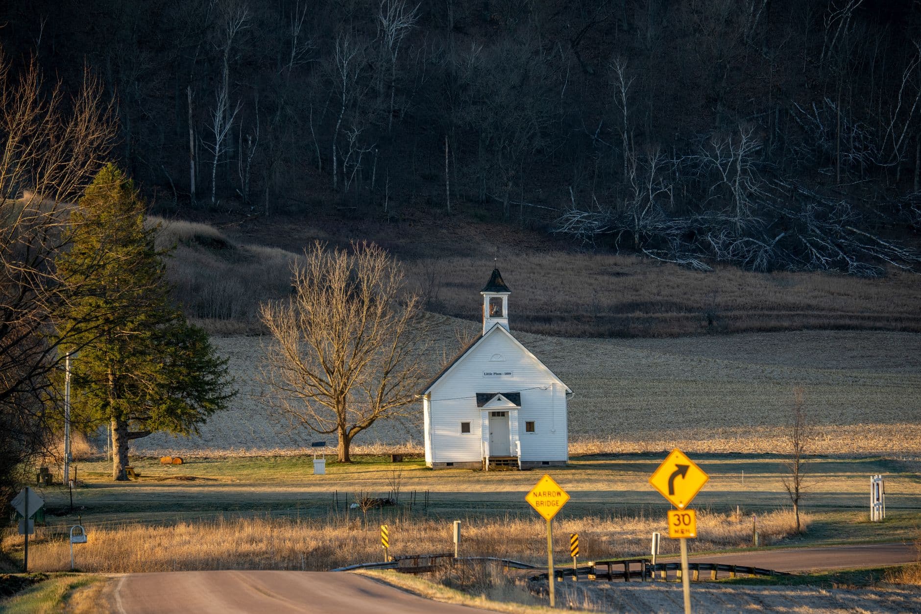 Scenic view of a quaint church surrounded by fields in Ella, Wisconsin, USA.