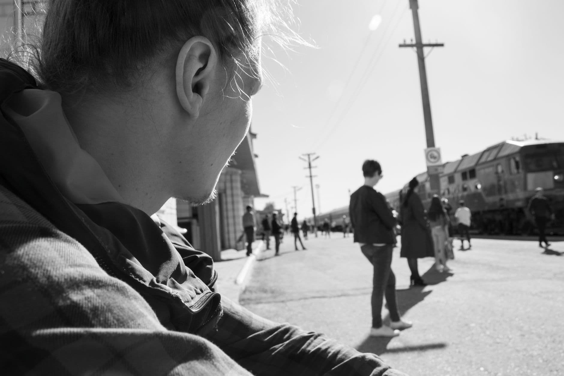A candid street photograph capturing everyday life in monochrome.
